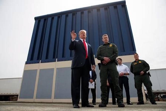 FILE - In this March 13, 2018 file photo, President Donald Trump talks with reporters as he reviews border wall prototypes in San Diego. Trump is floating the idea of using the military’s budget to pay for his long-promised border wall with Mexico. Trump raised the idea to House Speaker Paul Ryan at a meeting last week, according to a person familiar with the discussion who spoke on condition of anonymity. (AP Photo/Evan Vucci, File)