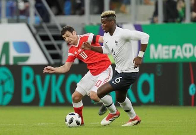 France’s Paul Pogba, right, duels for the ball with Russia’s Fyodor Smolov during the international friendly soccer match between Russia and France at the Saint Petersburg stadium in St.Petersburg, Russia, Tuesday, March 27, 2018. (AP Photo/Dmitri Lovetsky)