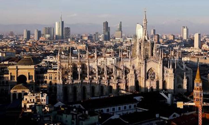 FILE - In this Jan. 4, 2017 file phtoo, the pinnacles of the Duomo cathedral are lit by the afternoon sun and backdropped by the new Business Center, in Milan, northern Italy. The Italian Olympic Committee sent a letter of intent to the IOC on Thursday, March 29, 2018, stating its plans of combining Milan and Turin to bid for the 2026 Winter Olympics. (AP Photo/Luca Bruno, files)