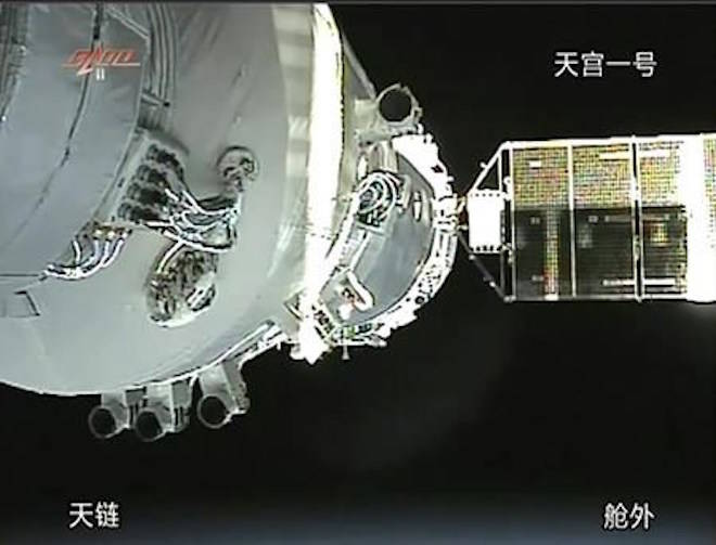 FILE - In this Nov. 3, 2011, file image taken from video from China’s CCTV via AP Video, China’s Shenzhou-8 spacecraft is docked with the orbiting Tiangong-1 space station. China’s defunct and believed out-of-control Tiangong 1 space station is expected to re-enter Earth’s atmosphere sometime in the coming days, although the risk to people and property on the ground is considered low. (CCTV via AP Video, File)