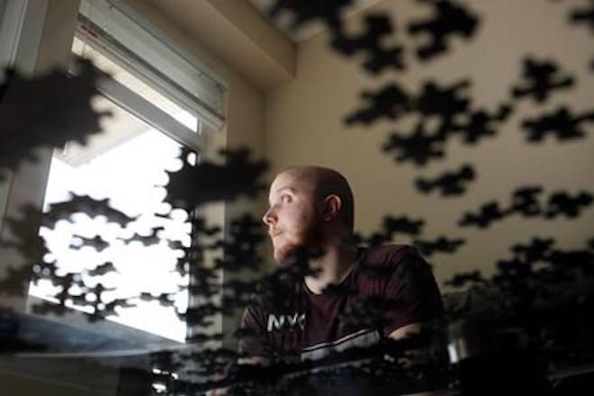 Kris Smith is photographed at home in Victoria, B.C., on Wednesday, March 28, 2018. His parents who live in the Yukon bought the unit for him while he completes school may be forced to sell due to B.C.’s new speculation tax. THE CANADIAN PRESS/Chad Hipolito