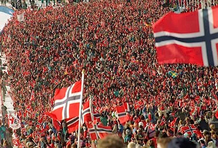 In this Feb. 25, 1994, file photo, a sea of Norwegian flags fill the stands waved by fans celebrating the sweep of the medal positions by the Norway alpine ski team in the men’s combined event in Hafjell, near Lillehammer, Norway. (AP Photo/Luca Bruno, File)