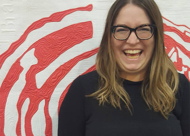 FEATURE QUILT MAKER - Jasmine Travers-Charbonneau stands in front of her quilt ‘Brassica’ that she designed and pieced using hand-stitched appliqué, quilted by Kathleen Riggins.                                Photo supplied