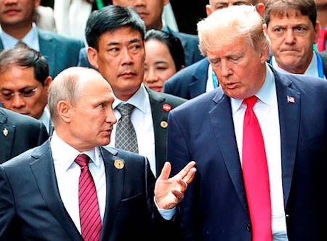 FILE - In this Nov. 11, 2017, file photo, President Donald Trump, right, and Russia President Vladimir Putin talk during the family photo session at the APEC Summit in Danang. The Trump administration is opening the door to a potential White House meeting between Trump and Putin. It would be the first time Putin has been at the White House in more than a decade and come at a time of rising tensions between the two global powers. (Mikhail Klimentyev, Sputnik, Kremlin Pool Photo via AP)