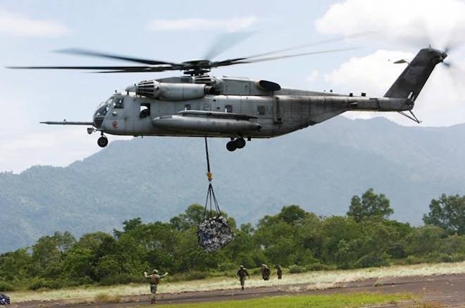 FILE - In this Saturday Oct. 10, 2009, file photo, a U.S. military helicopter, the CH-53E Super Stallion, airlifts humanitarian aid to be dropped in affected regions around Pariaman, north of Padang, Indonesia. On Tuesday, April 3, 2018, a CH-53E Super Stallion similar to the one shown went down shortly after 2:30 p.m., during a training mission near El Centro, Calif., a few miles from the U.S.-Mexico border. (AP Photo/Wong Maye-E, File)