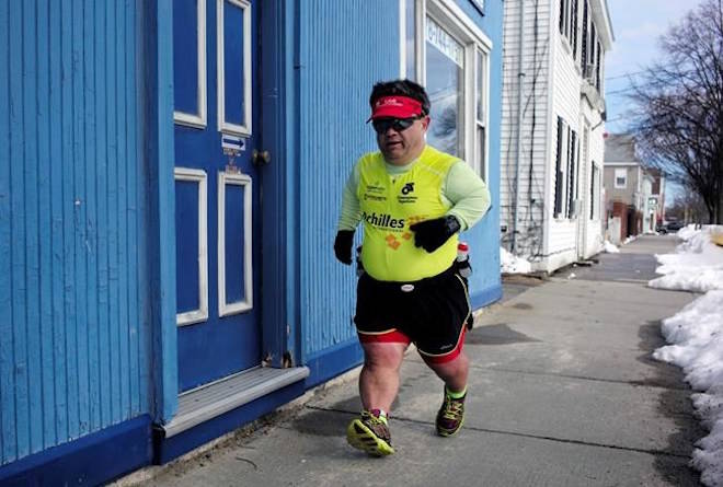 In this Thursday, March 15, 2018, photo, marathon runner John Young, of Salem, Mass., makes his way along a training route in Salem. Young was born with dwarfism, but that hasn’t stopped him from conquering multiple marathons and triathlons. While most marathoners take about 35,000 steps to reach the finish line, Young uses about 80,000. (AP Photo/Steven Senne)