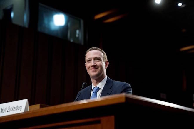 Facebook CEO Mark Zuckerberg smiles while testifying before a joint hearing of the Commerce and Judiciary Committees on Capitol Hill in Washington, Tuesday, April 10, 2018, about the use of Facebook data to target American voters in the 2016 election. (AP Photo/Andrew Harnik)