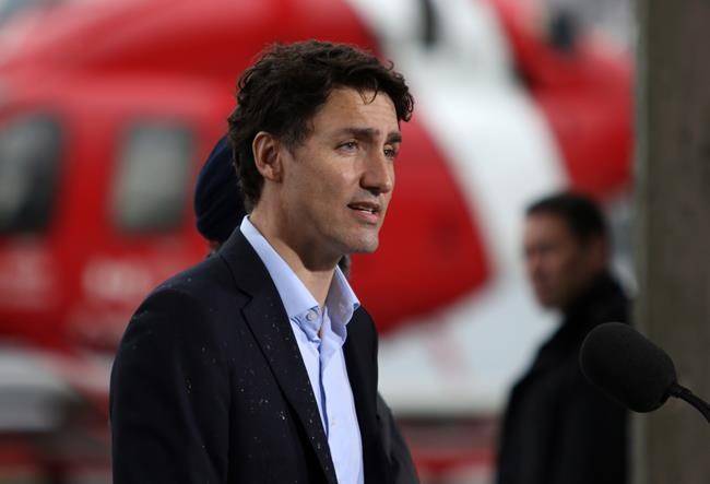 Prime Minister Justin Trudeau speaks to media after meeting with Canadian Coast Guard members aboard the Sir Wilfrid Laurier to discuss marine safety and spill prevention in Victoria on April 5, 2018. (Chad Hipolito/The Canadian Press)