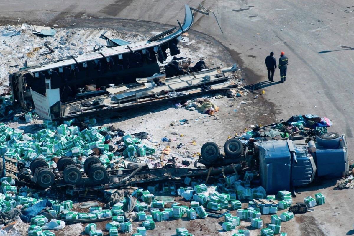 Emergency personnel work at the scene of a fatal crash outside of Tisdale, Saskatchewan, Canada, Saturday, April, 7, 2018. A bus, top, en route to Nipawin carrying the Humboldt Broncos junior hockey team crashed into a truck Friday night, killing 14 and sending over a dozen more to the hospital.(Jonathan Hayward/The Canadian Press via AP)
