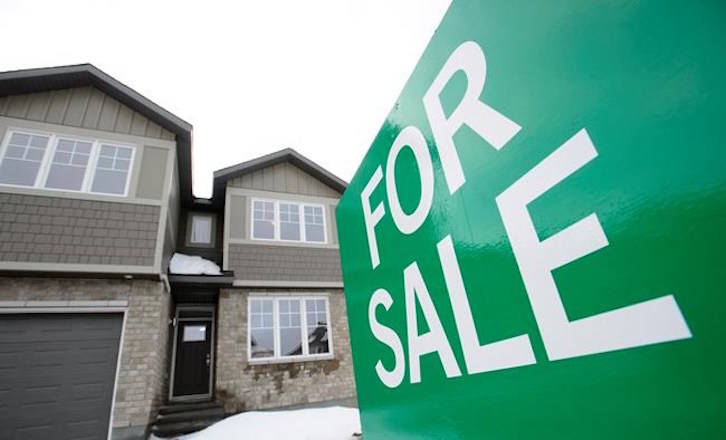 A for sale sign is shown in by new homes in Beckwith, Ont., just outside Ottawa, on Wednesday, Jan. 11, 2018. The number of Canadian homes sold in March plunged 22.7 per cent from the same month last year. The national average price was around $491,000, down 10.4 per cent from a year earlier. THE CANADIAN PRESS/Sean Kilpatrick