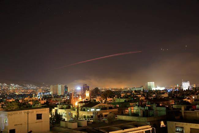 Explosions lit up the skies with anti-aircraft fire, over Damascus, the Syrian capital, as the U.S. launches an attack on Syria targeting different parts of the Syrian capital Damascus, Syria, early Saturday, April 14, 2018. (AP Photo/Hassan Ammar)