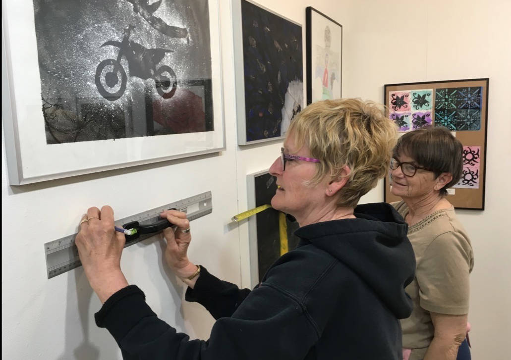 GETTING READY - Sue Barker and Sheila Wright help set up the Middle Schools Awesome Art Show, held in the Kiwanis Gallery through to May 21st.                                Mark Weber/Red Deer Express