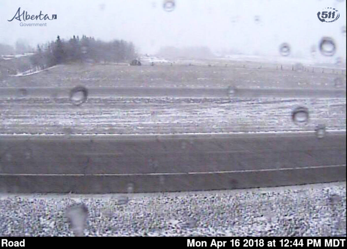 This highway camera image near the Morningside exit of Highway 2 shows the road conditions just before 1 p.m. on Monday. As the snow came down, certain areas were reported as partly snow covered and a semi was reported jackknifed by Innisfail’s Antler Hill.                                511 Alberta photo