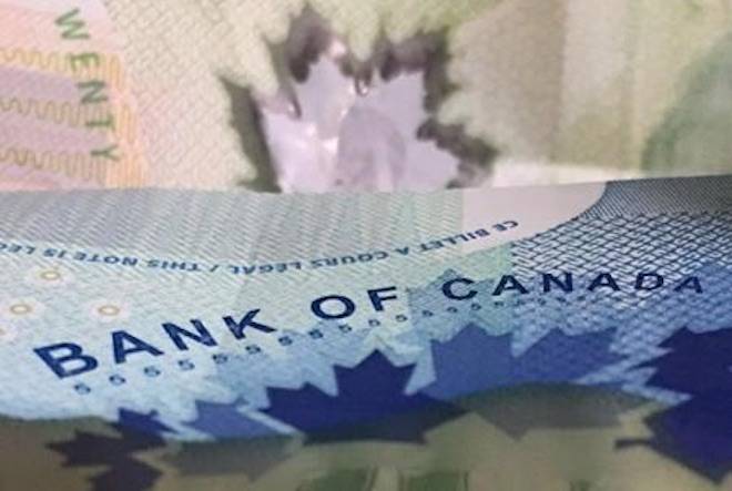 The Bank of Canada will decide today whether to continue raising interest rates, and will issue its latest predictions for the Canadian economy. Canadian bank notes are seen, in Ottawa on Wednesday, September 6, 2017. THE CANADIAN PRESS/Adrian Wyld