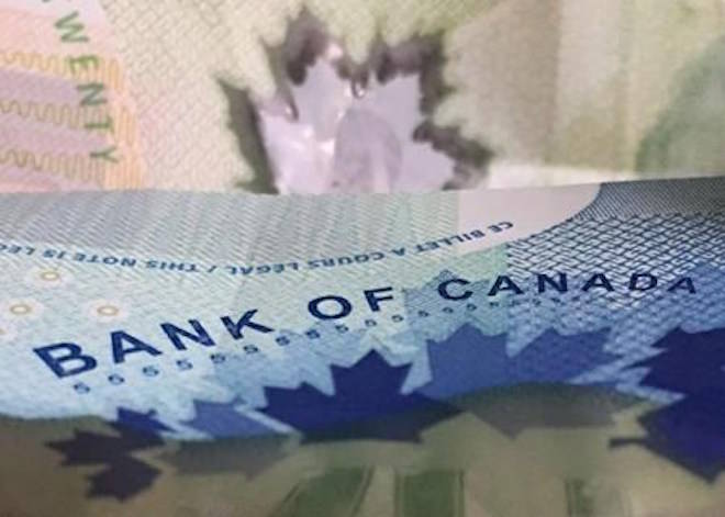 The Bank of Canada will decide today whether to continue raising interest rates, and will issue its latest predictions for the Canadian economy. Canadian bank notes are seen, in Ottawa on Wednesday, September 6, 2017. THE CANADIAN PRESS/Adrian Wyld