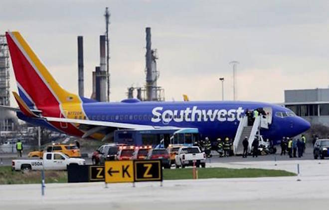 A Southwest Airlines plane sits on the runway at the Philadelphia International Airport after it made an emergency landing in Philadelphia, on Tuesday, April 17, 2018. (David Maialetti/The Philadelphia Inquirer via AP)