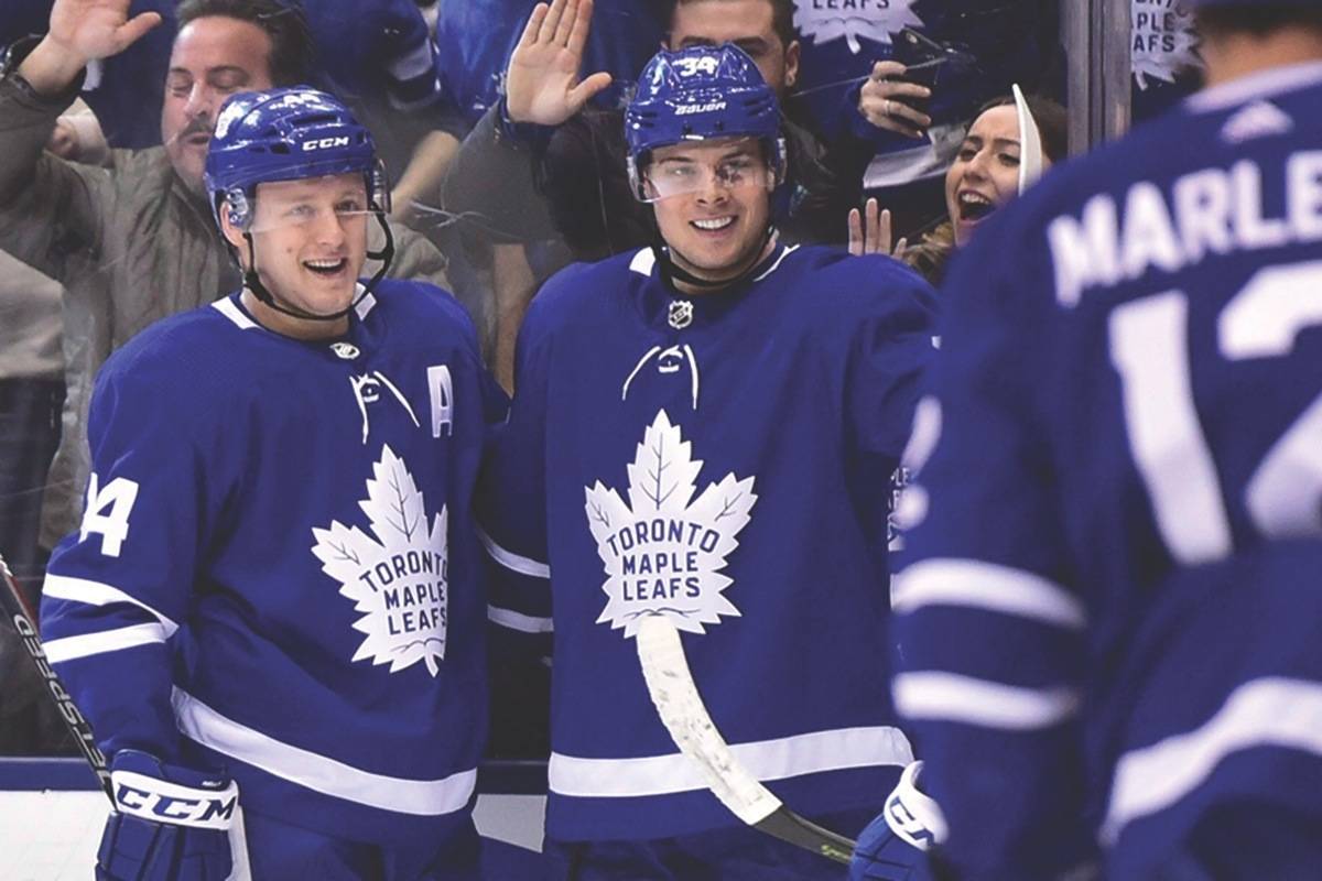 Toronto Maple Leafs centre Auston Matthews (centre) celebrates his goal against the Buffalo Sabres with teammates Morgan Rielly (left) and Patrick Marleau (12) during second period NHL hockey action in Toronto on Monday, April 2, 2018. (Frank Gunn/The Canadian Press)