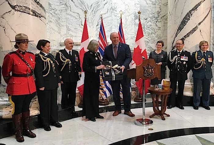 B.C. Premier John Horgan presents outgoing BC Lt.-Gov. Judith Guichon with a saddle pad for her horse in Victoria on Monday, April 23, 2018. Guichon is a life long rancher from Merritt, B.C. The saddle pad is embroidered with the official crest of B.C. and her office. THE CANADIAN PRESS/Dirk Meissner