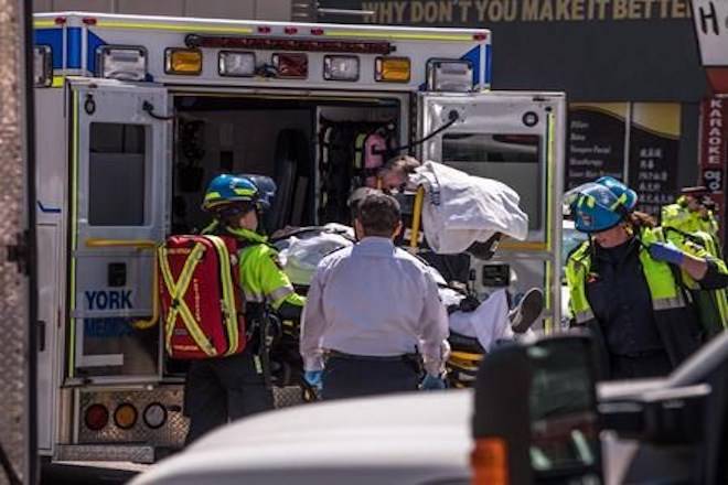 A injured person is put into the back of an ambulance in Toronto after a van mounted a sidewalk crashing into a number of pedestrians on Monday, April 23, 2018. THE CANADIAN PRESS/Aaron Vincent Elkaim