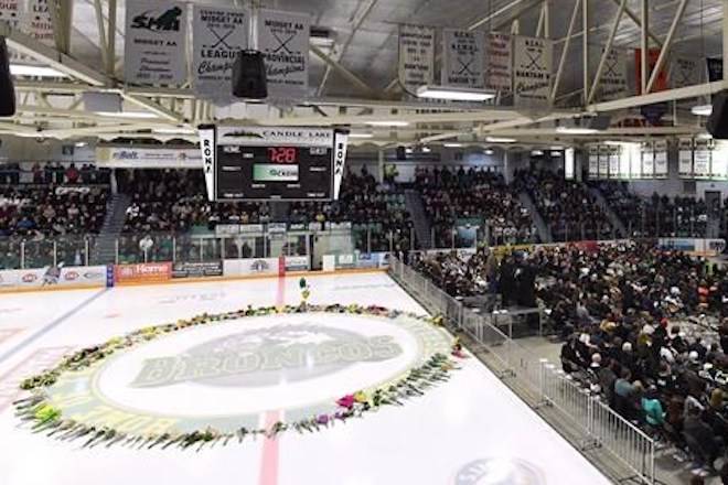 Flowers lie at centre ice as people gather for a vigil at the Elgar Petersen Arena, home of the Humboldt Broncos, to honour the victims of a fatal bus accident in Humboldt, Sask. on April 8, 2018. THE CANADIAN PRESS