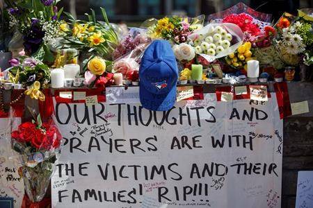 Tributes are seen on a memorial at Yonge St. and Finch Ave. in Toronto on Thursday, April 26, 2018 for the victims of Monday’s deadly van attack. (Cole Burston/The Canadian Press)