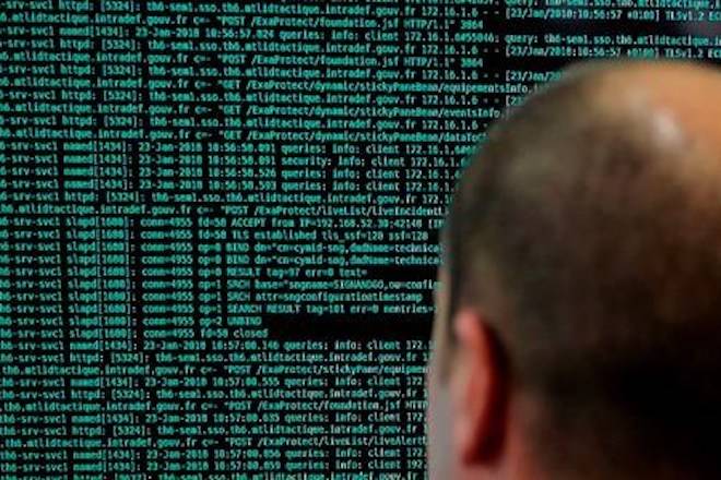 FILE - In this Jan.23 2018 file photo, a French solider watches code lines on his computer at the French Defense ministry stand during the International Cybersecurity forum in Lille, northern France. Police in Europe and North America have seized servers and data from Islamic State propaganda outlets in a multi-country operation aimed at tracking down radicals and crimping the group’s ability to spread its violent message. (AP Photo/Michel Spingler, File)