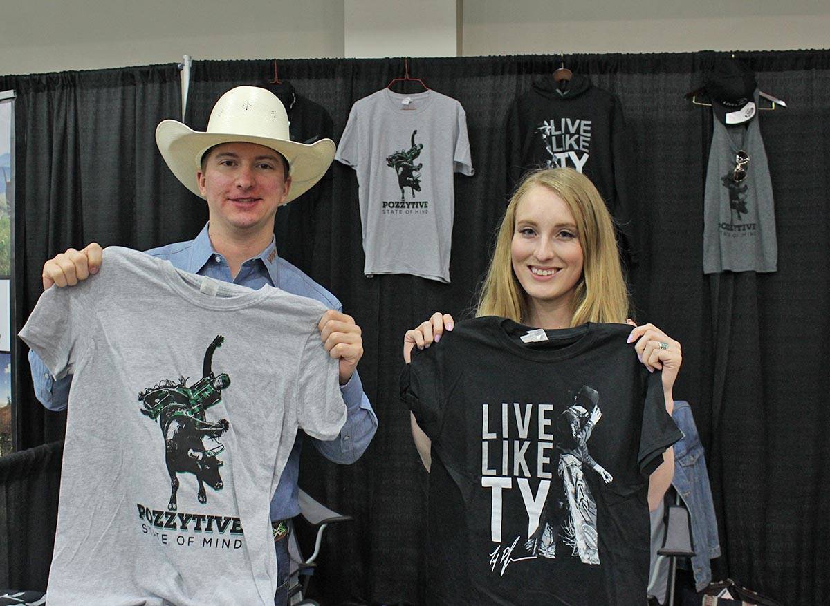 LIVE LIKE TY - Ted Stovin and Hailey Stewart hold up Live Like Ty merchandise at their stall at The Mane Event at Westerner Park. Carlie Connolly/Red Deer Express