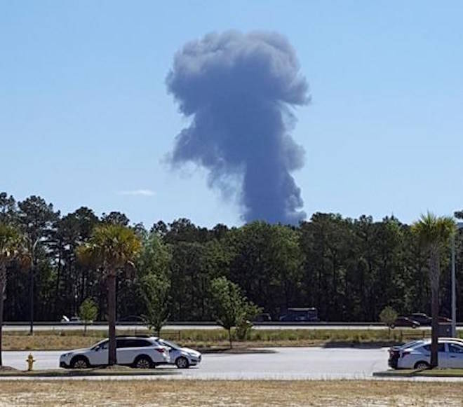 Smoke rises in the distant where an Air National Guard C-130 cargo plane crashed near an in Savannah, Ga., Wednesday, May 2, 2018, in this view from Poolers, Ga. (Minh Phan via AP)