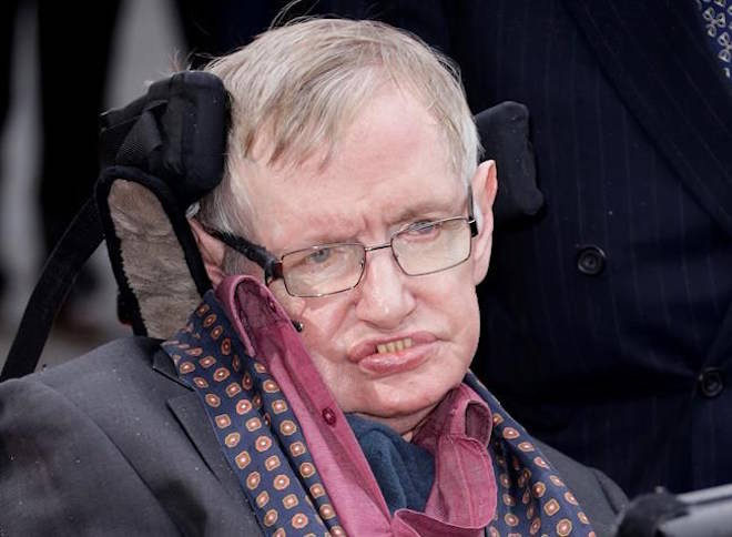 FILE - In this March 30, 2015, file photo, Professor Stephen Hawking arrives for the Interstellar Live show at the Royal Albert Hall in central London. Hawking’s final theory on the origin of the universe has been published in a journal. The University of Cambridge, where Hawking worked, said on Wednesday, May 2, 2018, the theory was submitted for publication before his death in March at age 76. (Photo by Joel Ryan/Invision/AP, File)