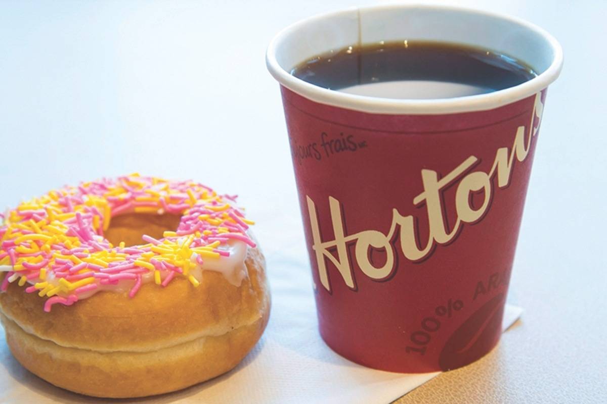 A coffee and donut from Tim Hortons is seen at a Coquitlam B.C., location on April 26, 2018. THE CANADIAN PRESS/Jonathan Hayward