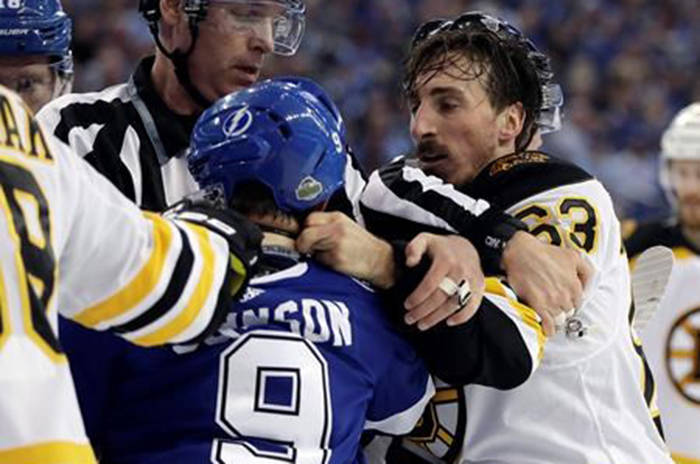 Boston Bruins left wing Brad Marchand (63) and Tampa Bay Lightning centre Tyler Johnson (9) scrap during the first period of Game 2 of an NHL second-round hockey playoff series Monday, April 30, 2018. (Chris O’Meara/The Canadian Press)