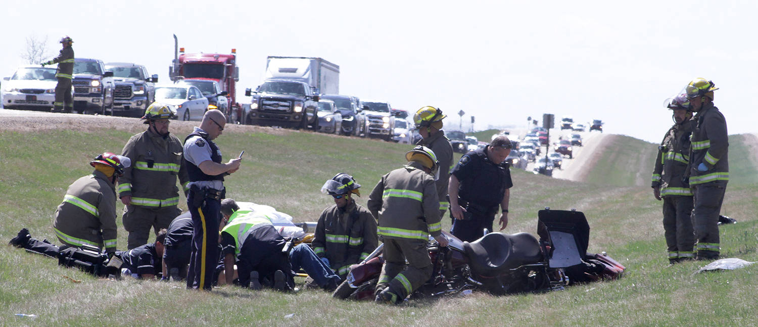 Emergency crews attend to a motorcycle driver involved in a collision with another motorcycle on Highway 2 south of Ponoka Sunday afternoon. Both northbound and southbound lanes were backed up for some time while the scene was cleared. Members of the Ponoka County East District Fire Department and the Ponoka Integrated Traffic Unit and EMS crews attended.                                Photo by Jeffrey Heyden-Kaye