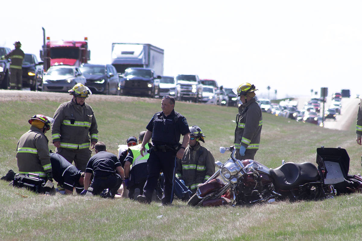 Emergency crews attend to a motorcycle driver involved in a collision with another motorcycle on Highway 2 south of Ponoka Sunday afternoon. Both northbound and southbound lanes were backed up for some time while the scene was cleared. Members of the Ponoka County East District Fire Department and the Ponoka Integrated Traffic Unit and EMS crews attended.                                Photo by Jeffrey Heyden-Kaye