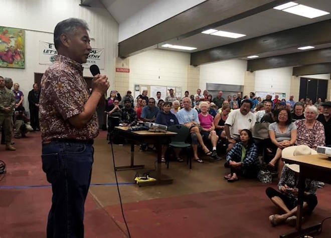 Hawaii Gov. David Ige speaks at a community meeting, Monday, May 7, 2018, in Pahoa, Hawaii. Two new cracks in the ground emitting lava and gas have opened up in a Hawaii community where multiple structures have burned down. Residents of the evacuated subdivision are being allowed to check on their properties from 7 a.m. to 6 p.m. every day until further notice. Officials say residents must be prepared to leave on short notice. (AP Photo/Haven Daley)