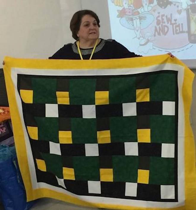 Dale Gilbert holds a quilt in Qatar in this undated handout photo. It’s 11,097 kilometres from Doha to Humboldt, Saskatchewan but the fatal crash between a bus carrying junior hockey players hit close to home for Dale Gilbert and her husband Scott. THE CANADIAN PRESS/Handout/Jay Branch