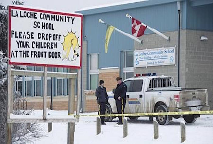 Members of the RCMP stand outside the La Loche Community School in La Loche, Sask. Monday, Jan. 25, 2016. A sentencing hearing is expected for a young man that killed four people at a home and school in northern Saskatchewan. Two teenage brothers along with a teacher and a teacher’s aide died in the January 2016 shooting in La Loche, Sask.THE CANADIAN PRESS/Jonathan Hayward