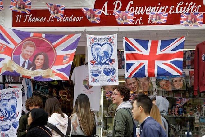 Royal memorabilia on sale near Windsor Castle in Windsor, England, Friday, May 11, 2018. All roads seem to lead to Windsor Castle, a magnificent fortress perched high on a hill topped by the royal standard when the queen is in residence. It is here, a favoured royal playground since William the Conqueror built the first structure here in 1070, that the royal wedding of Prince Harry and Meghan Markle will take place. (AP Photo/Alastair Grant)