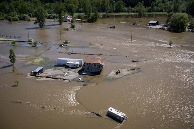 A home damaged by floodwaters is seen in an aerial view, near the Kettle River in Grand Forks, B.C., on Saturday May 12, 2018. Thousands of people have been evacuated from their homes in British Columbia’s southern interior as officials warn of flooding due to extremely heavy snowpacks, sudden downpours and unseasonably warm temperatures. THE CANADIAN PRESS/Darryl Dyck