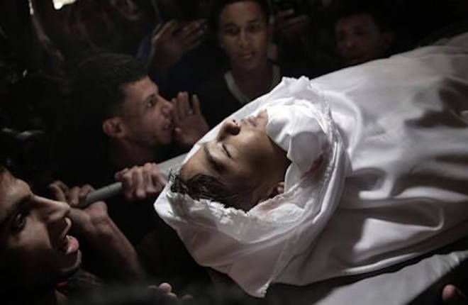 Mourners chant angry slogans as they carry the body of 15 year-old Palestinian Jamal Afaneh during his funeral in Rafah refugee camp, southern Gaza Strip, Sunday, May 13, 2018. Afaneh died from his injuries after being shot on Friday by Israeli troops during the ongoing protest along the Gaza Strip border with Israel. (AP Photo/Khalil Hamra)