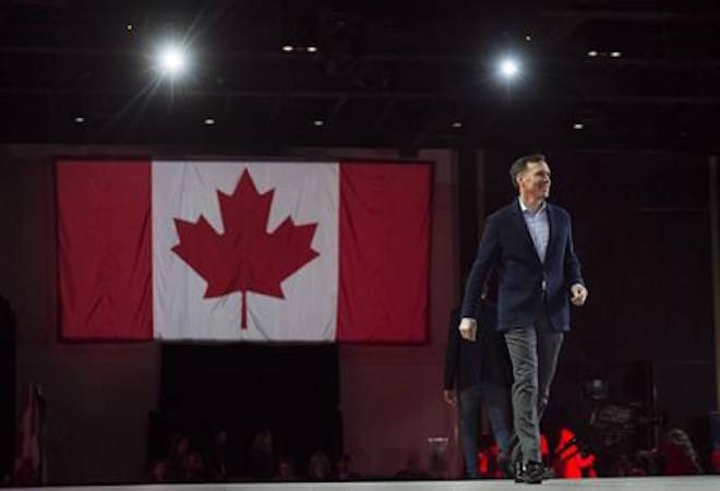 Bill Morneau, Minister of Finance, walks on stage before delivering a speech at the federal Liberal national convention in Halifax on Saturday, April 21, 2018. Morneau will provide an update Wednesday on the status of his talks with Kinder Morgan to expedite the Trans Mountain pipeline expansion, but he is not expected to announce a deal. THE CANADIAN PRESS/Darren Calabrese