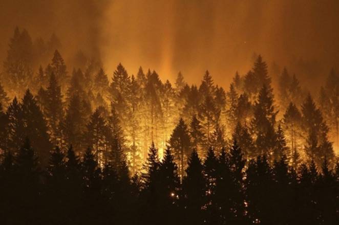 The Eagle Creek wildfire burns on the Oregon side of the Columbia River Gorge near Cascade Locks, Ore., on Sept. 5, 2017. (Genna Martin / seattlepi.com via AP)