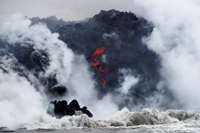 FILE - In this May 20, 2018 file photo, lava flows into the ocean near Pahoa, Hawaii. (AP Photo/Jae C. Hong, File)
