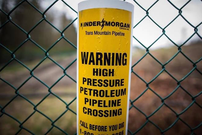 A sign warning of an underground petroleum pipeline is seen on a fence at Kinder Morgan’s facility where work is being conducted in preparation for the expansion of the Trans Mountain Pipeline, in Burnaby, B.C., on Monday April 9, 2018. With just over a week remaining until the deadline set for abandoning the Trans Mountain pipeline expansion, no suitors have emerged to step into builder Kinder Morgan Canada’s shoes. THE CANADIAN PRESS/Darryl Dyck
