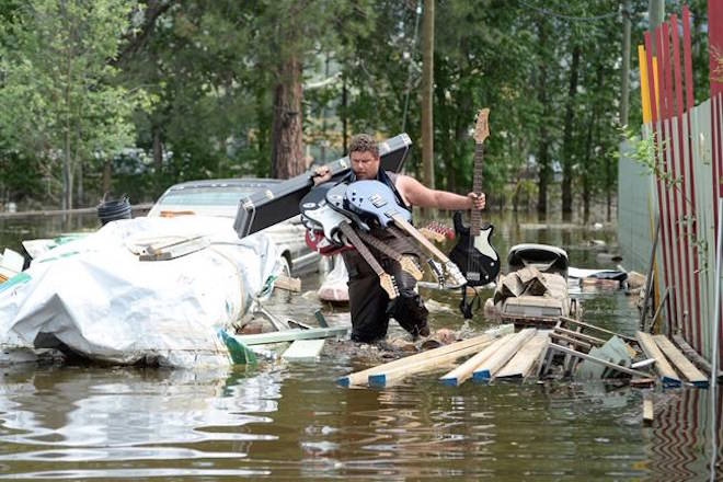 Resident Lars Androsoff carries his friend’s guitars as he walks through the floodwaters in Grand Forks, B.C., on Thursday, May 17, 2018. Dawn Harp and Androsoff were fully confident flooding didn’t threaten their home near southern British Columbia’s Kettle River.Then the couple awoke May 11 to the sound of floodwaters flowing beneath their Grand Forks home’s floorboards.THE CANADIAN PRESS/Jonathan Hayward