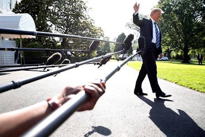 President Donald Trump waves while walking away after speaking to the media, as he walks to the Marine One helicopter Friday, May 25, 2018, on the South Lawn of the White House in Washington. Trump is traveling to Annapolis to address the U.S. Naval Academy graduation ceremonies. (AP Photo/Jacquelyn Martin)