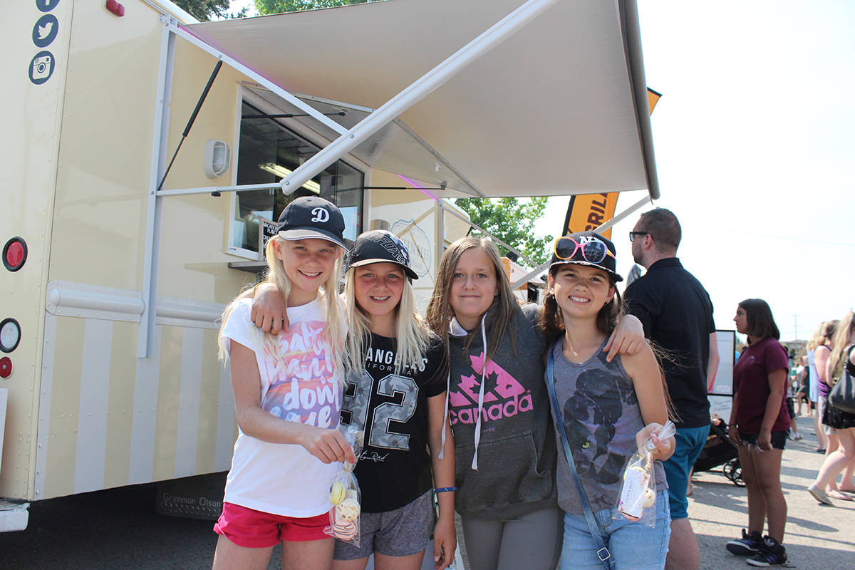 FOOD TRUCK FRIDAYS - Sianna Holt, Adalia Hansen, Selina Douziech, Jordynn Myers and Camryn Murdoch enjoy some food at the first Food Truck Fridays of the year in the parking lot of Carnival Cinemas. Carlie Connolly/Red Deer Express