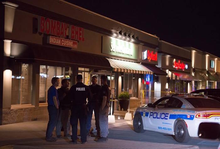 Police stand outside the Bombay Bhel restaurant in Mississauga, Ont. on Friday May 25, 2018. Fifteen people were injured Thursday night when an explosion police say was caused by an “improvised explosive device” ripped through a restaurant in Mississauga. Ontario. THE CANADIAN PRESS/Doug Ives