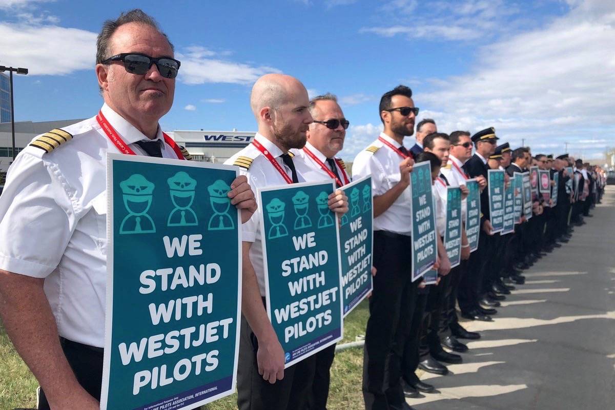 Pilots standing in solidarity with WestJet. (garybrussell/Twitter)