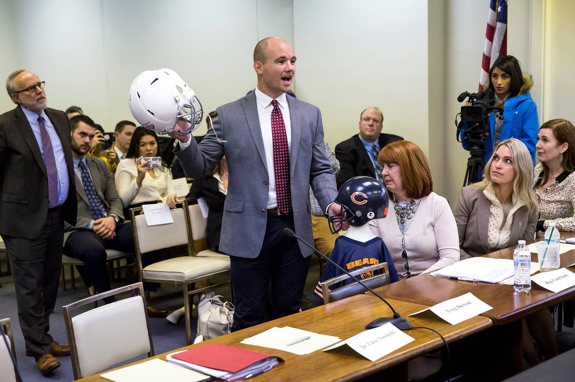 FILE - In this March 1, 2018, file photo, Chris Borland, a former NFL linebacker and Big Ten Defensive Player of the Year for the University of Wisconsin, testifies before a Illinois House Mental Health Committee hearing in Springfield, Ill., on House Bill 4341, which would ban tackle football for kids under 12 years of age. (Rich Saal//The State Journal-Register via AP, File)