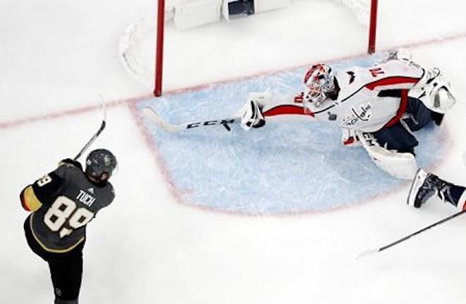 Washington Capitals goaltender Braden Holtby, right, makes a stick save on shot by Vegas Golden Knights right wing Alex Tuch during the third period in Game 2 of the NHL hockey Stanley Cup Finals on Wednesday, May 30, 2018, in Las Vegas. (AP Photo/John Locher)